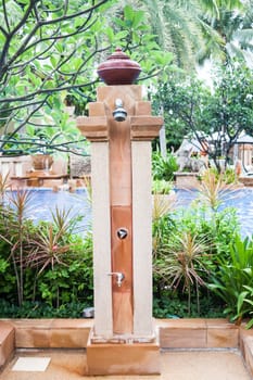 Outdoor shower at swimming pool in resort