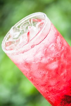 Fresh and cold red drink with ice cubes