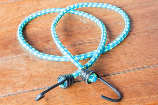 Light blue rubber band with metal hooks