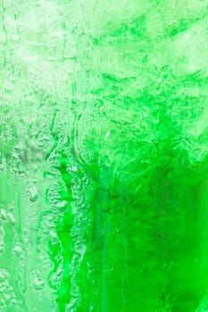 Sweet green water with ice cubes background