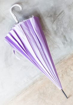 Purple uv protection umbrella on the floor