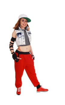 A lovely woman in red pants, jeans jacket and a hat standing .isolated on white background..
