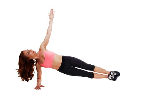 A pretty slim woman lying on the floor doing leg exercise, isolated.on white background..