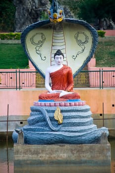 Snake Muchalinda spreads hood and protects meditating Buddha from violent wind and rains at Mahabodi Temple, Bodhgaya, Bihar, India, Asia