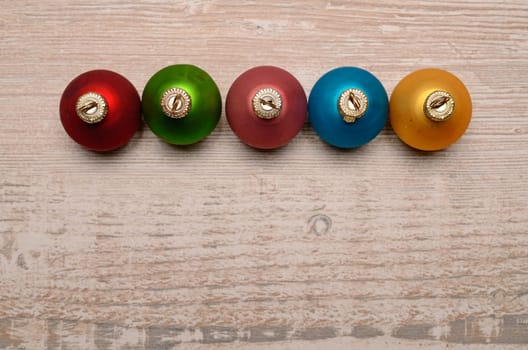 Old vintage Christmas baubles on a rustic wooden background with space for text