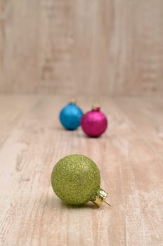 Christmas baubles on a rustic wooden background