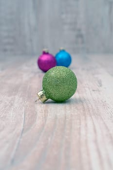 Christmas baubles on a rustic wooden background