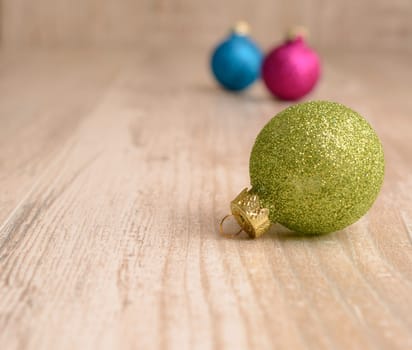 Christmas baubles on a rustic wooden background