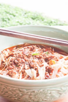 Spicy noodle in meat soup with chopsticks