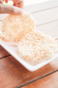 Hand hold thai style crispy rice cracker