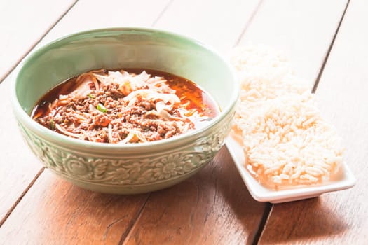 Traditional spicy noodle and crispy rice cracker