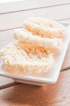 Thai style crispy rice cracker on white plate