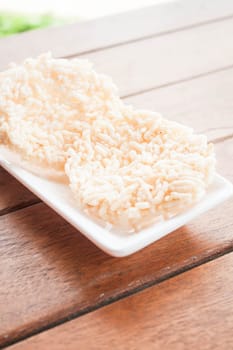 White dish of thai style crispy rice cracker