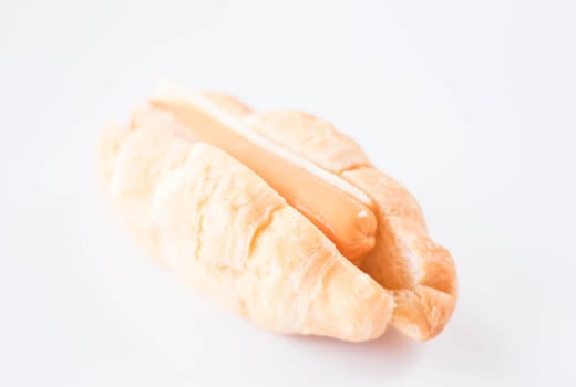 Delicious sausage and cheese croissant on white background