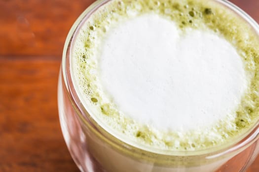 Hot matcha green tea latte in glass