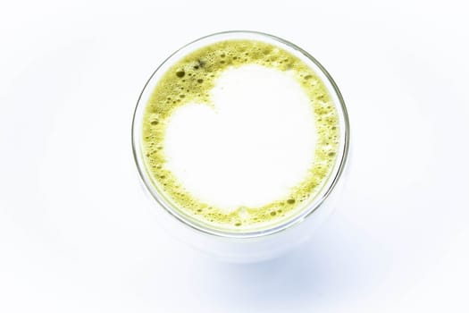 Hot glass of green tea latte isolated on white background