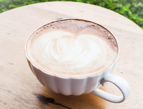 Free pour hot coffee latte cup serving in garden