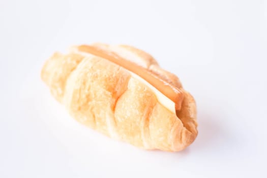 Croissant with sausage and cheese isolated on white background