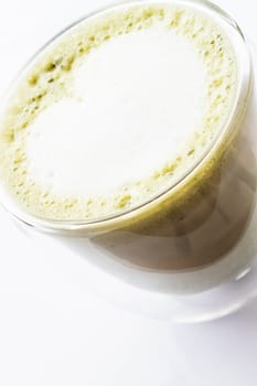 Hot matcha green tea latte isolated on white background
