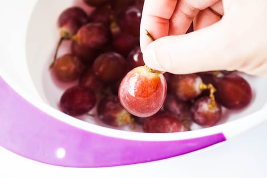 Hand on fresh grape before consume, stock photo