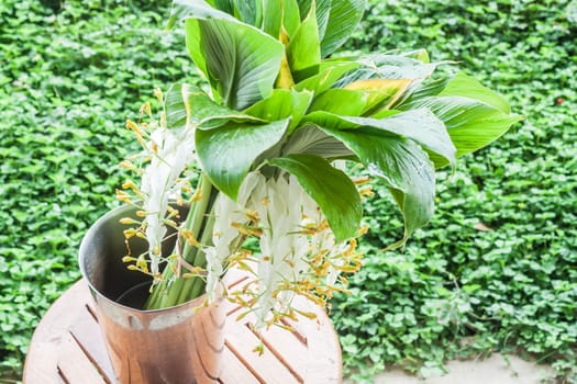 Fresh flowers lent in metallic vase, stock photo