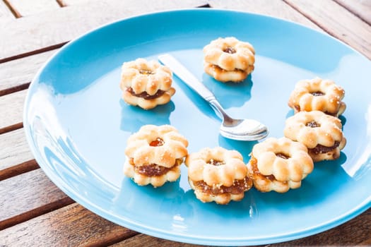 Smiling face of pineapple biscuits on wood table, stock photo