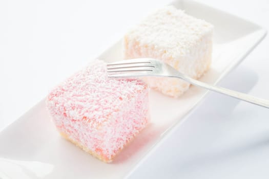 Lamington sponge cakes and fork, stock photo