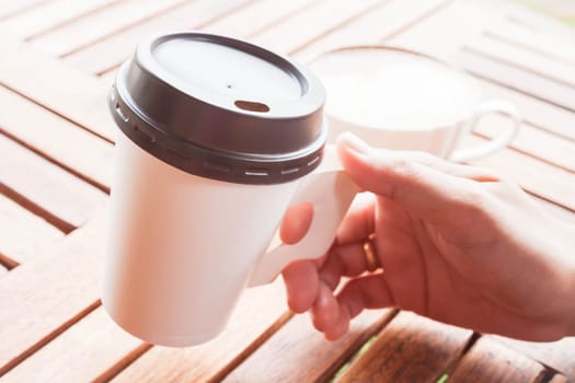 Hot coffee in paper cup serving at coffee shop