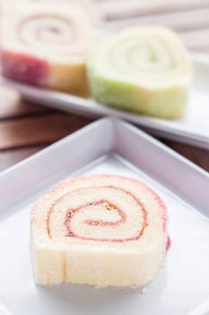 Colorful jam rolls served on wood table, stock photo