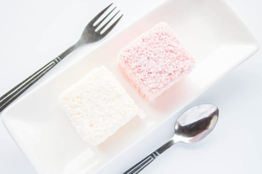 Pink and white lamington sponge cakes, stock photo