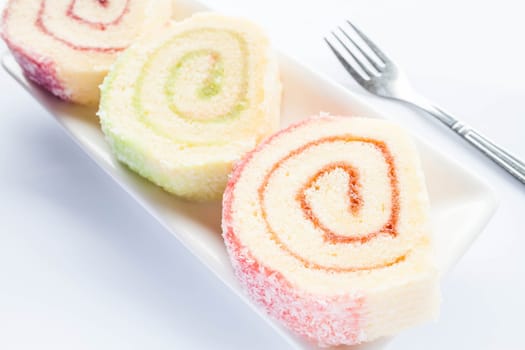 Set of colorful jam roll cakes with fork, stock photo