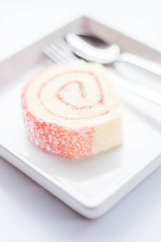 Sweet dish of pink jam roll cake, stock photo