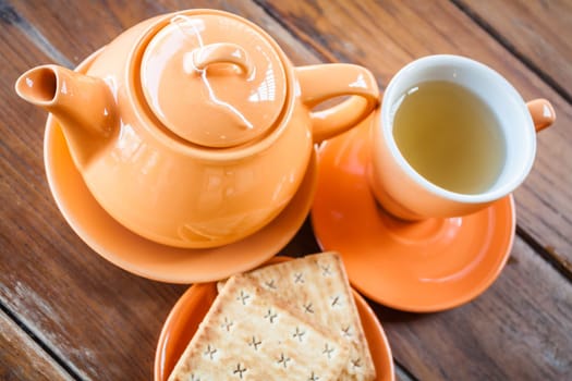 Hot teapot with cup and crackers, stock photo