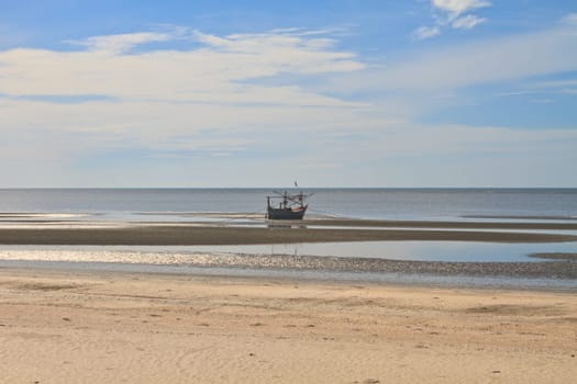 Fishing boat on the beach in summer