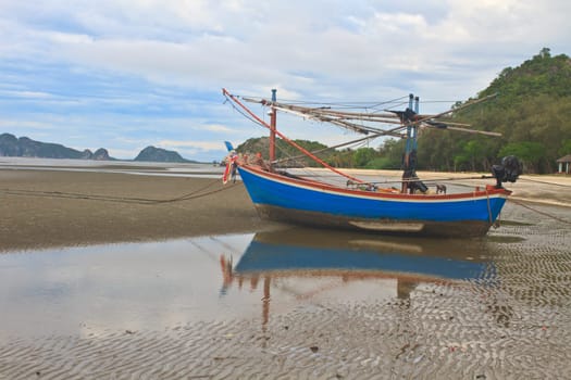 Fishing boat on the beach in summer