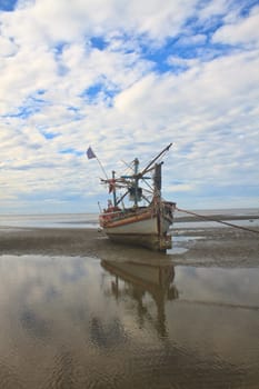 Fishing boat on the beach in summer