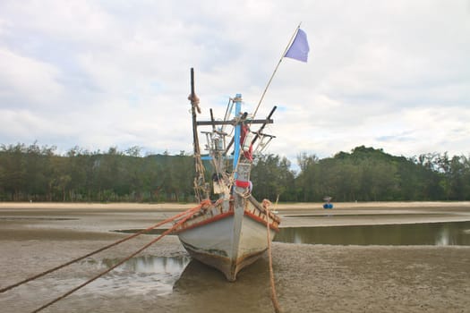 Fishing boat on the beach in summer