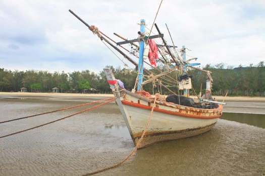 Fishing boat on the beach in summer