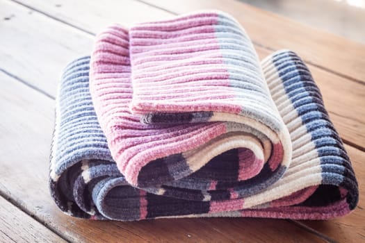 Close up striped scarf on wood table, stock photo