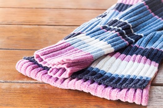 Close up knit wool scarf on wood table, stock photo