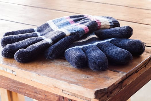 Close up winter gloves on wood table, stock photo