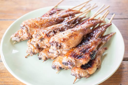 Grilled chicken wings serving on wood table, stock photo