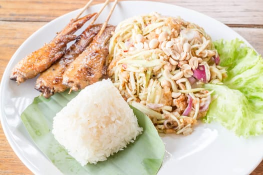 Set of green mango salad chicken grill and sticky rice, stock photo