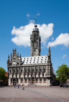 MIDDELBURG, THE NETHERLANDS - JULY 1, 2014  Unidentified people in front of the famous city hall of Middelburg on July 1 in Middelburg, Zeeland, The Netherlands, .