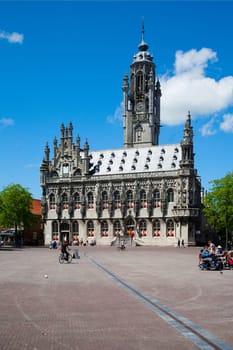MIDDELBURG, THE NETHERLANDS - JULY 1, 2014  Unidentified people in front of the famous city hall of Middelburg on July 1 in Middelburg, Zeeland, The Netherlands, .