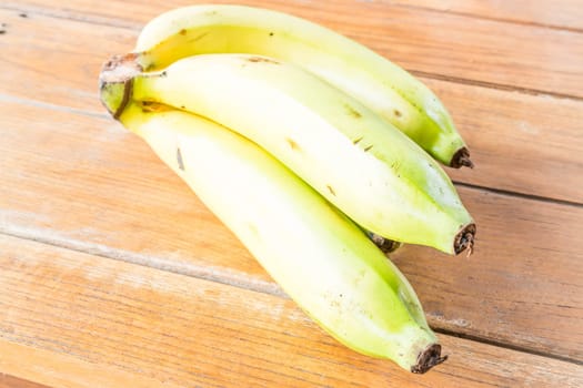 Fresh bunch of bananas on wooden table, stock photo