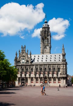 MIDDELBURG, THE NETHERLANDS - JULY 1, 2014  Unidentified people in front of the famous city hall of Middelburg on July 1 in Middelburg, Zeeland, The Netherlands, .