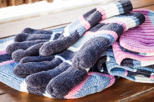 Set of winter wool accessories on wood table