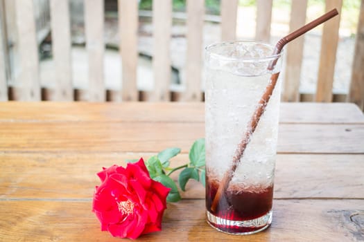 Iced pomegranate drink on wood table, stock photo