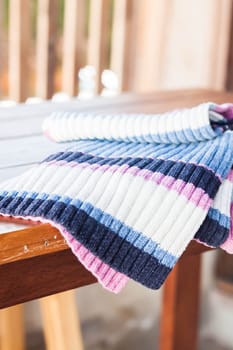 Winter scarf on wood table, stock photo